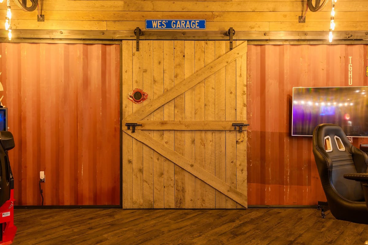 Barn door and TV at Hanks Garage Venue