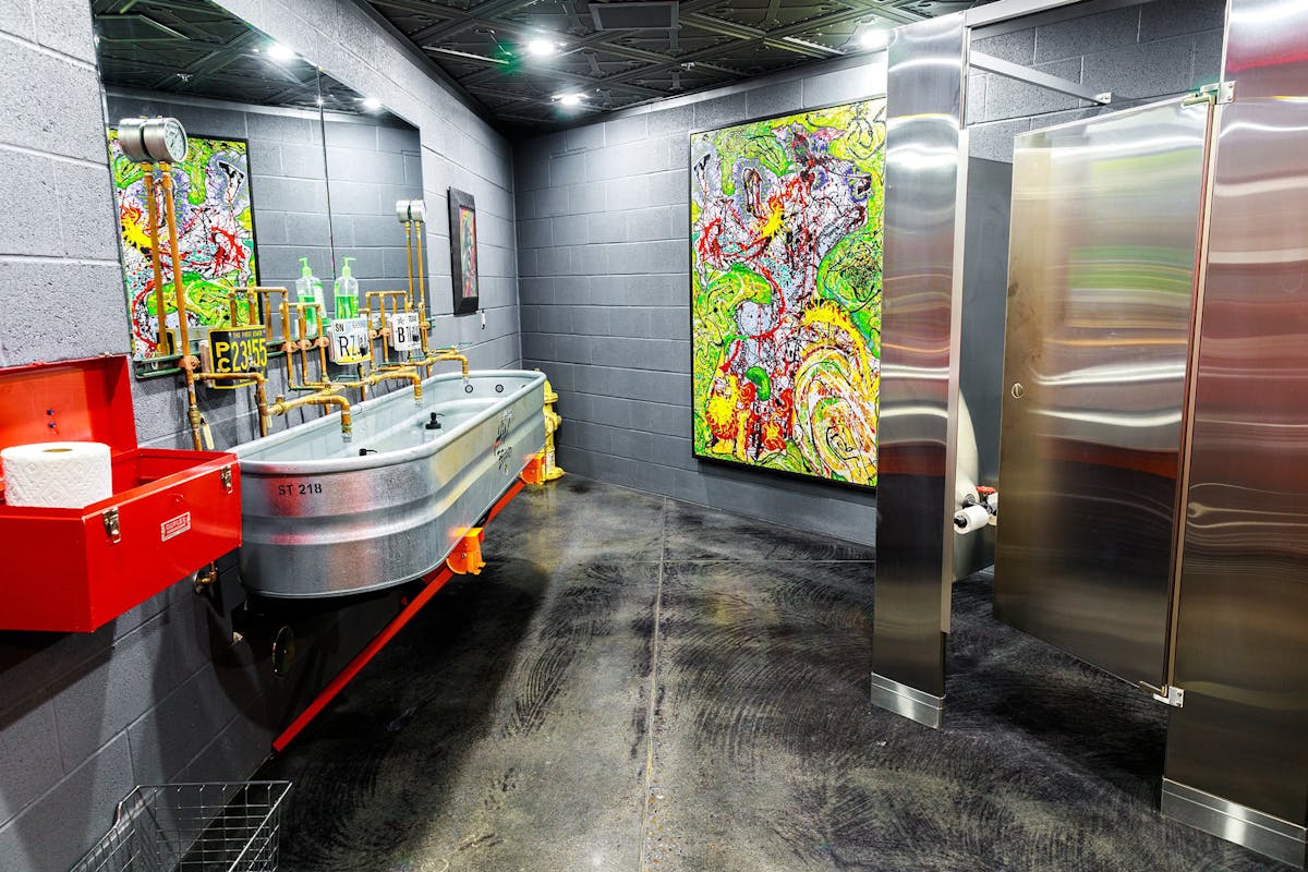 Bathroom with art at Hanks Garage Venue